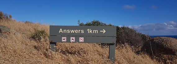 Image of sign in Australia that says Answers 1km