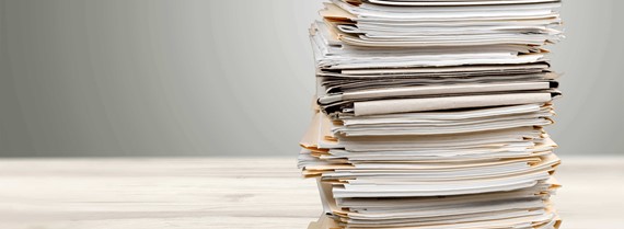Image of pile of documents on a desk