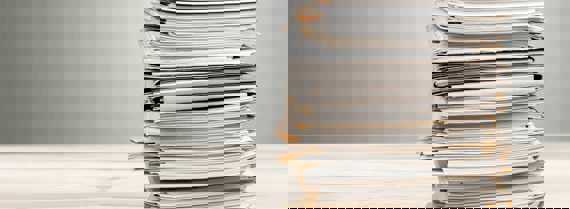 Image of pile of documents on a desk