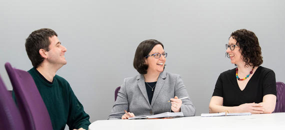 Three team member at the conference table.
