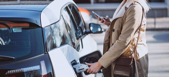 Woman Charging Electro Car Electric Gas Station (Cropped)