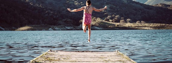 Image of girl leaping into a lake