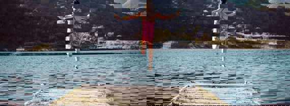 Image of girl leaping into a lake