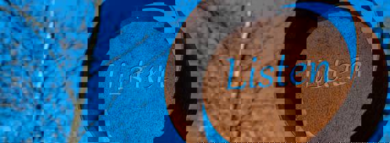 Image of the word 'listen' on an outdoor metal sculpture
