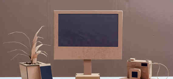 Cardboard prototype of calculator, cellphone, computer with keyboard and photocamera.