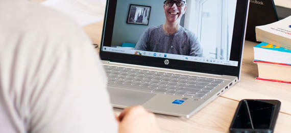 A researcher interviewing a person online.