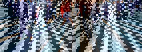 People crossing street on zebra in a city